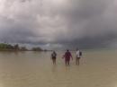 Clamming with the Girls: Wendy of "Kookaburra," Laiza, and Rose of "Aussie Rules" wading into the lagoon behind Laiza